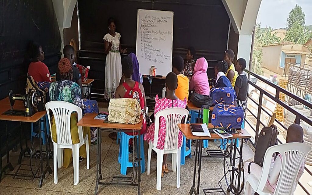 Participants attending a community training session with sewing equipment and an instructor