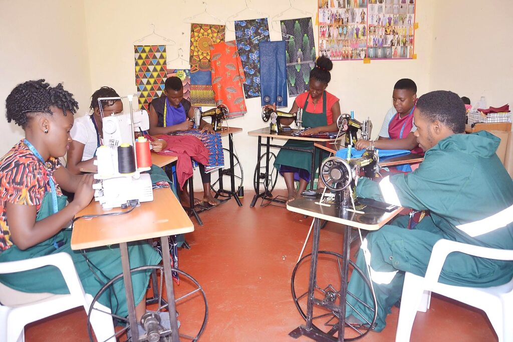 Participants learning sewing and garment-making skills in a vocational workshop